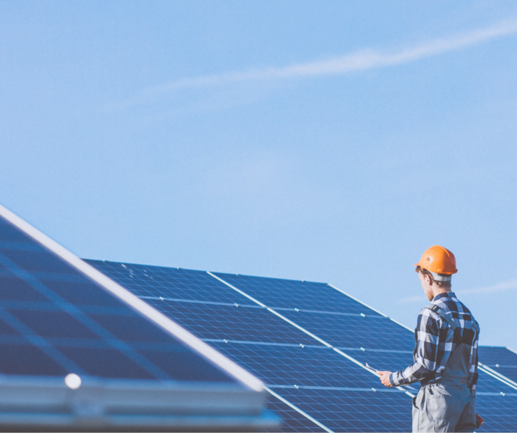 Handwerker auf einem Dach mit Photovoltaikanlage